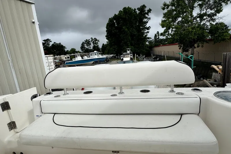 Slide: The Image of 2007 Robalo R300 Center Console boat seat with rod holders, overcast sky background. - 3