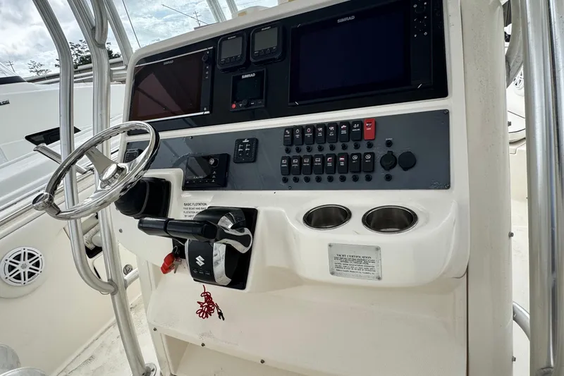 Slide: The Image of 2007 Robalo R300 Center Console helm with steering wheel and control panel. - 7