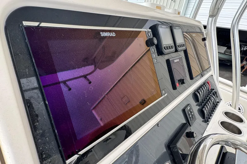 Slide: The Image of 2007 Robalo R300 Center Console dashboard with Simrad electronics and control panel. - 8
