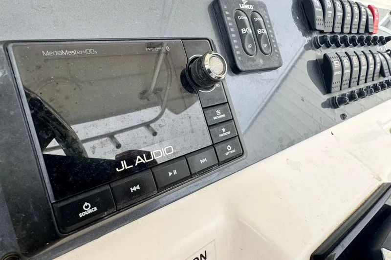 Slide: The Image of Control panel of a 2007 Robalo R300 Center Console boat featuring JL Audio system. - 9