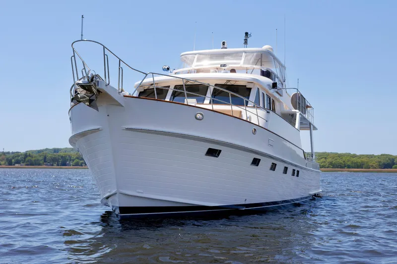 Slide: The Image of 2007 Grand Banks 59 Aleutian RP yacht on calm water, clear sky background. - 102