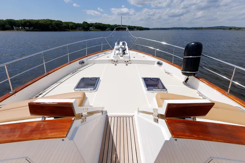 Slide: The Image of 2007 Grand Banks 59 Aleutian RP yacht deck with seating, cruising on calm waters. - 26