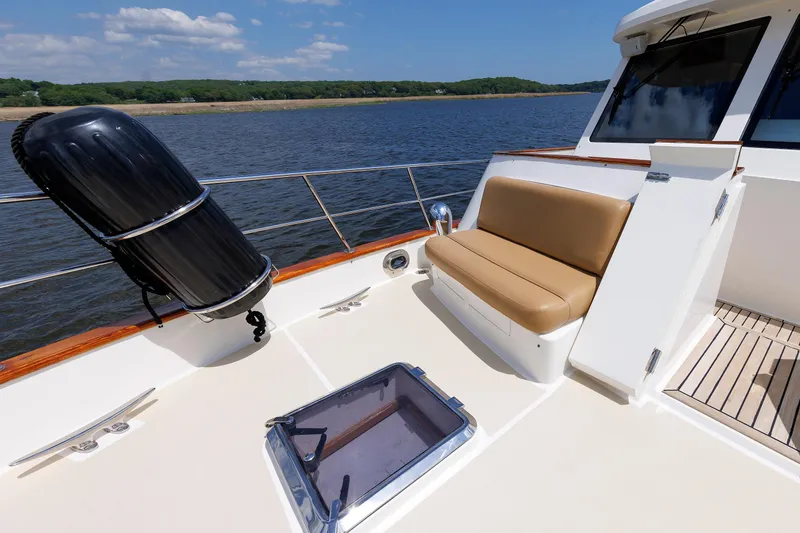 Slide: The Image of 2007 Grand Banks 59 Aleutian RP yacht deck with seating and scenic water view. - 28