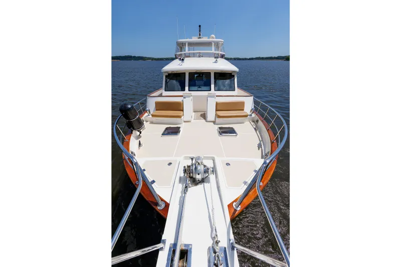 Slide: The Image of 2007 Grand Banks 59 Aleutian RP yacht on calm water, showcasing spacious deck and seating. - 30
