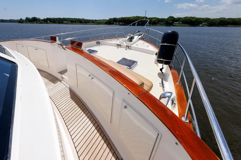 Slide: The Image of 2007 Grand Banks 59 Aleutian RP yacht deck with wooden railings on a sunny day. - 32