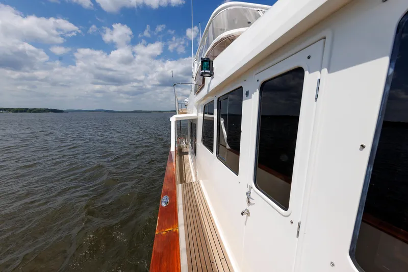 Slide: The Image of 2007 Grand Banks 59 Aleutian RP yacht cruising on open water under a partly cloudy sky. - 33