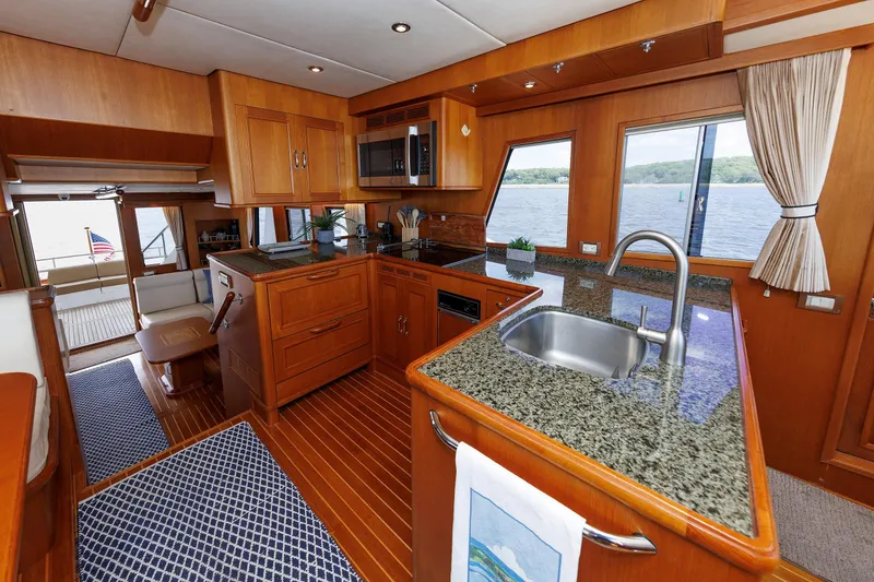 Slide: The Image of Luxurious 2007 Grand Banks 59 Aleutian RP yacht interior with elegant kitchen and scenic water views. - 42