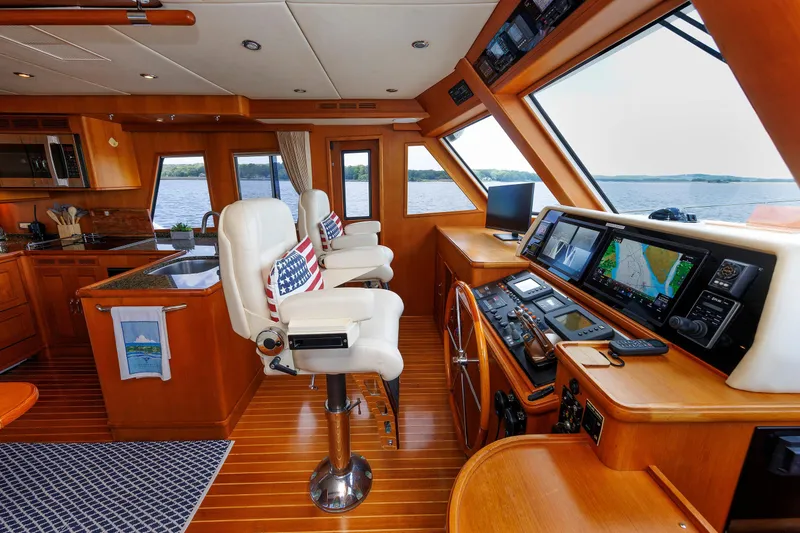 Slide: The Image of Luxurious 2007 Grand Banks 59 Aleutian RP yacht interior with helm, navigation equipment, and seating. - 50