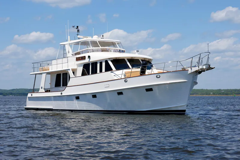 Slide: The Image of 2007 Grand Banks 59 Aleutian RP yacht on calm water under blue sky. - 6