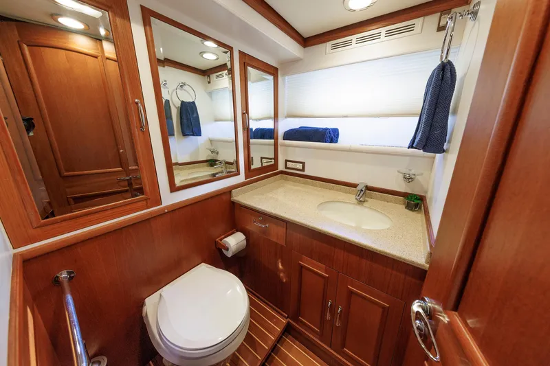 Slide: The Image of Luxurious 2007 Grand Banks 59 Aleutian RP yacht bathroom with wood cabinetry and modern fixtures. - 60