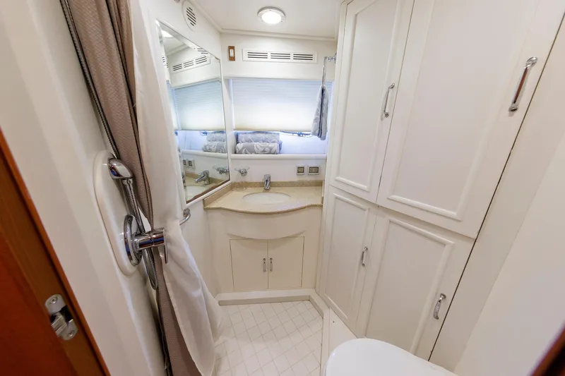 Slide: The Image of Luxurious bathroom interior of 2007 Grand Banks 59 Aleutian RP yacht, featuring elegant cabinetry. - 61