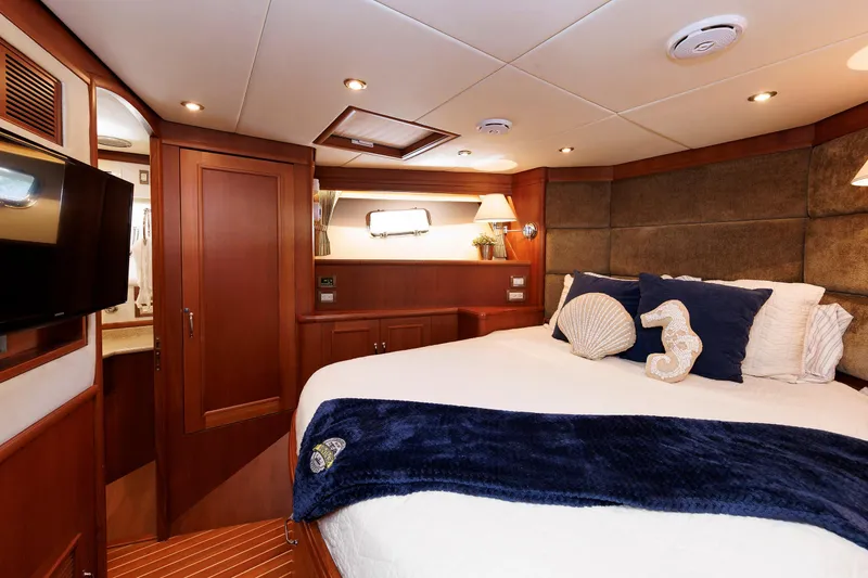 Slide: The Image of Luxurious cabin interior of 2007 Grand Banks 59 Aleutian RP yacht with elegant bedding. - 64