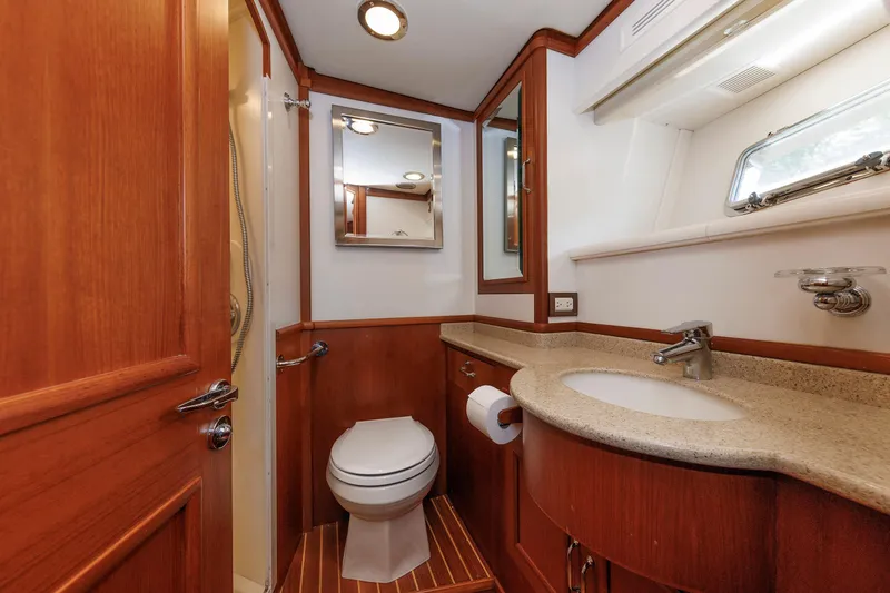 Slide: The Image of Luxurious 2007 Grand Banks 59 Aleutian RP yacht bathroom with wood accents and modern fixtures. - 65