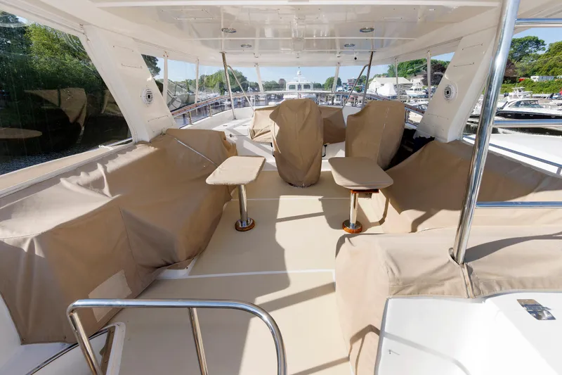 Slide: The Image of Luxurious 2007 Grand Banks 59 Aleutian RP yacht deck with covered seating and tables. - 83