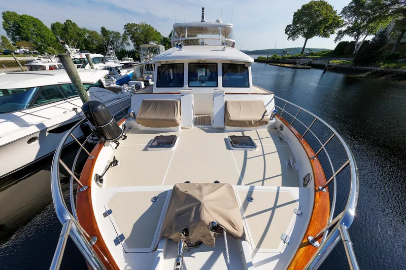 Slide: The Image of 2007 Grand Banks 59 Aleutian RP yacht docked, showcasing spacious deck and elegant design. - 87