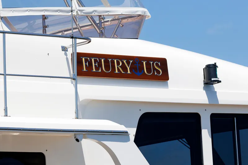 Slide: The Image of 2007 Grand Banks 59 Aleutian RP yacht with "FEURYUS" nameplate and anchor design. - 91