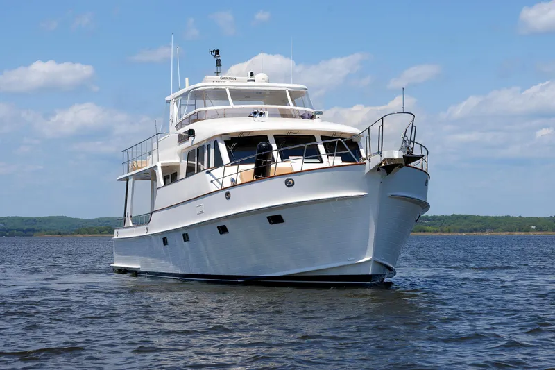 Slide: The Image of 2007 Grand Banks 59 Aleutian RP yacht on calm water under blue sky. - 94