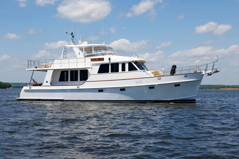 Slide: The Image of 2007 Grand Banks 59 Aleutian RP yacht on calm water under blue sky. - 97