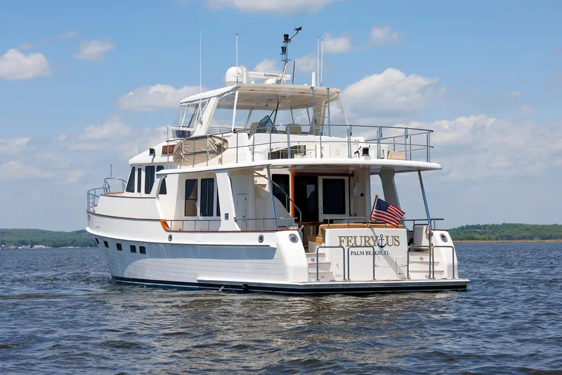 Slide: The Image of 2007 Grand Banks 59 Aleutian RP yacht on calm water under blue sky. - 99