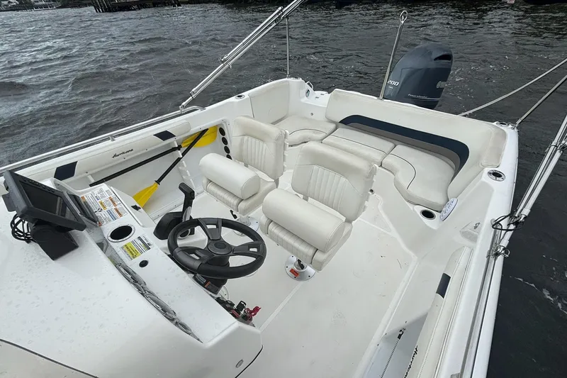 Slide: The Image of 2015 Hurricane SunDeck Sport 231 OB boat interior with steering wheel and seating. - 12