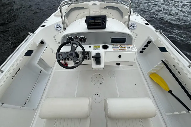 Slide: The Image of 2015 Hurricane SunDeck Sport 231 OB boat cockpit with steering wheel and controls. - 13