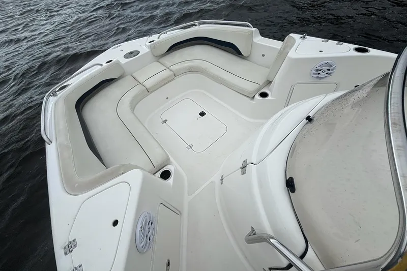 Slide: The Image of 2015 Hurricane SunDeck Sport 231 OB boat interior with seating and storage compartments. - 8