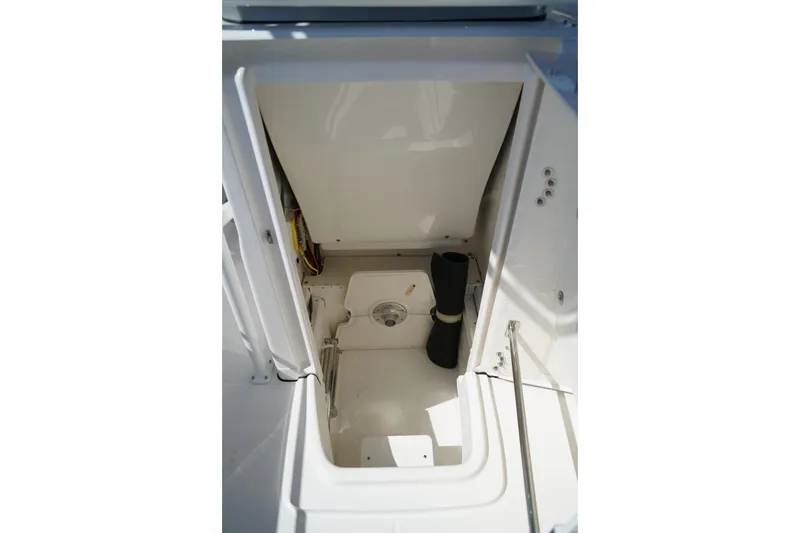 Slide: The Image of 2025 Robalo R200 Center Console storage compartment interior view. - 14