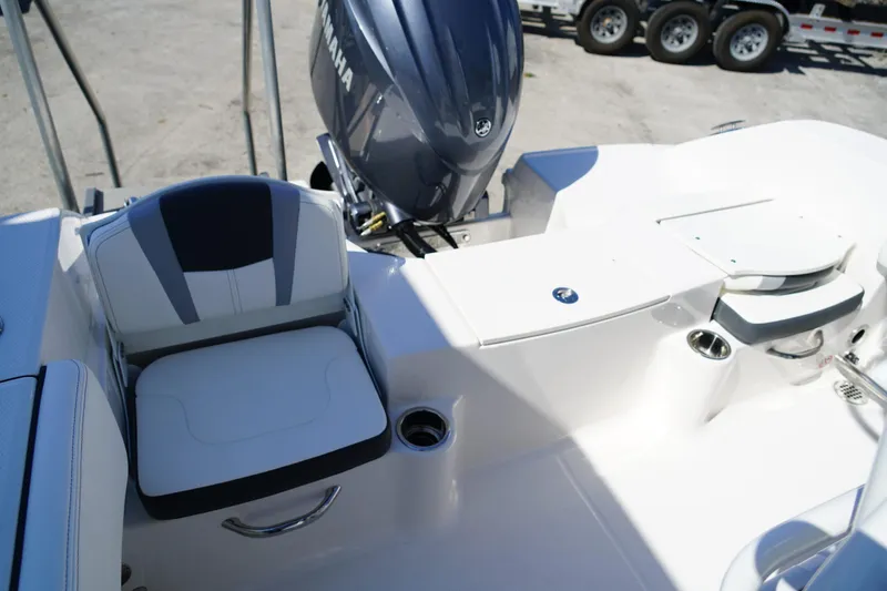 Slide: The Image of 2025 Robalo R200 Center Console boat interior with seating and Yamaha engine. - 18