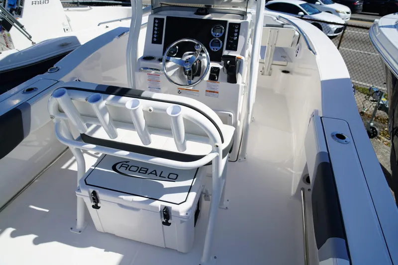Slide: The Image of 2025 Robalo R200 Center Console boat interior with steering wheel and rod holders. - 20