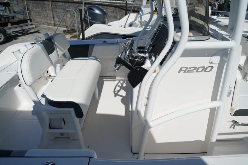 Slide: The Image of 2025 Robalo R200 Center Console boat interior with seating and steering console. - 21