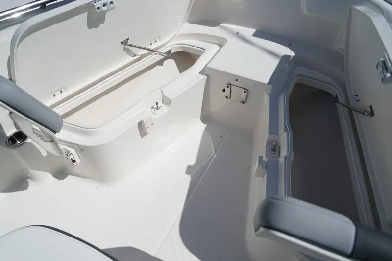 Slide: The Image of 2025 Robalo R200 Center Console boat interior with open storage compartments. - 9