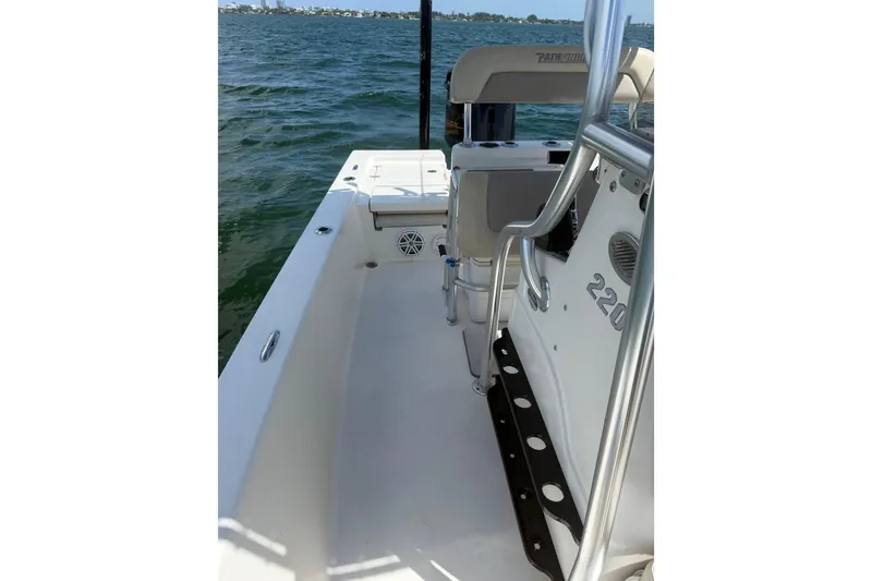 Slide: The Image of 2012 Pathfinder 2200 TRS boat interior on open water, showcasing seating and console. - 10