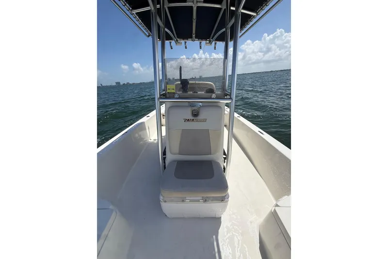 Slide: The Image of 2012 Pathfinder 2200 TRS boat on water, featuring center console and seating. - 14