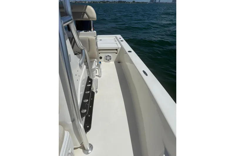 Slide: The Image of 2012 Pathfinder 2200 TRS boat interior with seating and rod holders on open water. - 9
