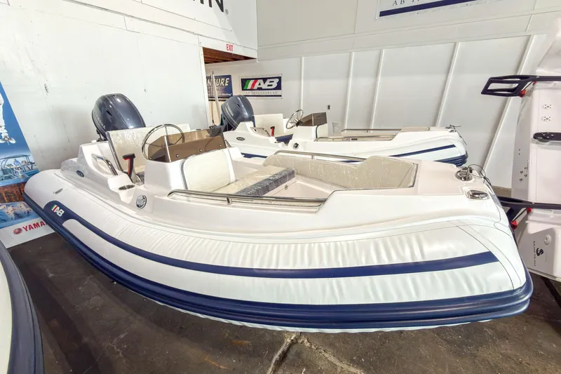 The Image of 2024 AB Inflatables Nautilus 13 boat displayed in showroom, featuring sleek design and Yamaha engine. - 0