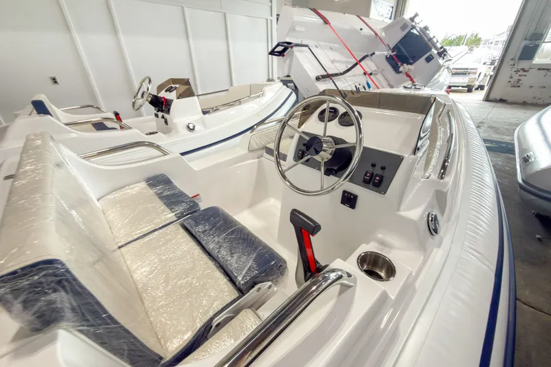 Slide: The Image of 2024 AB Inflatables Nautilus 13 boat interior with steering wheel and seating. - 1