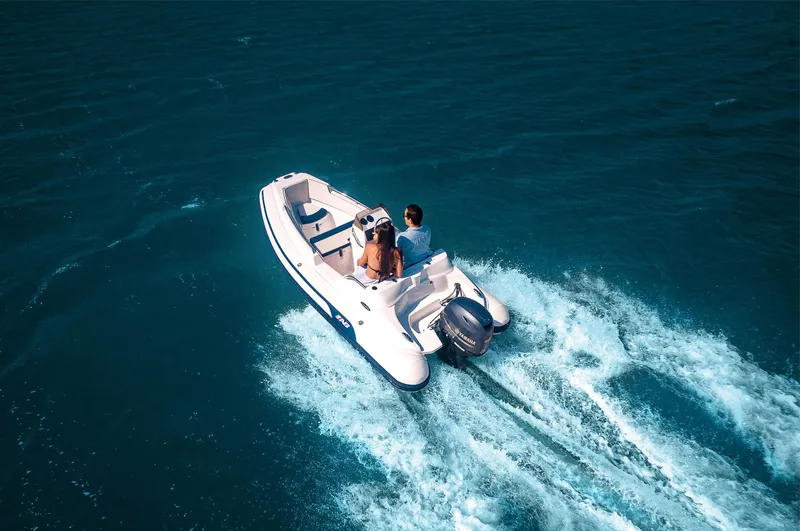 Slide: The Image of 2024 AB Inflatables Nautilus 13 DLX cruising on open water. - 6