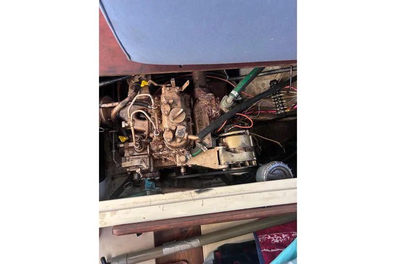 Slide: The Image of 1981 Catalina 30 engine compartment with visible wiring and mechanical components. - 12
