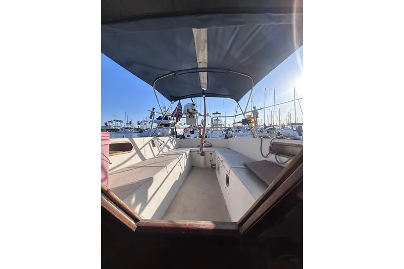 Slide: The Image of Cockpit view of a 1981 Catalina 30 sailboat docked in a sunny marina. - 6