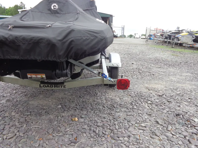 Slide: The Image of 2023 Sea-Doo FishPro Sport 170 on trailer, covered, on gravel lot. - 38