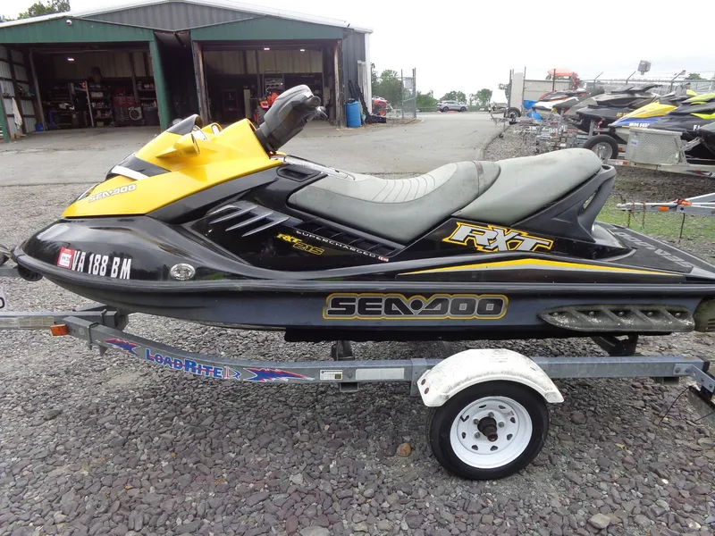 The Image of 2007 Sea-Doo RXT jet ski on trailer outside workshop. - 1