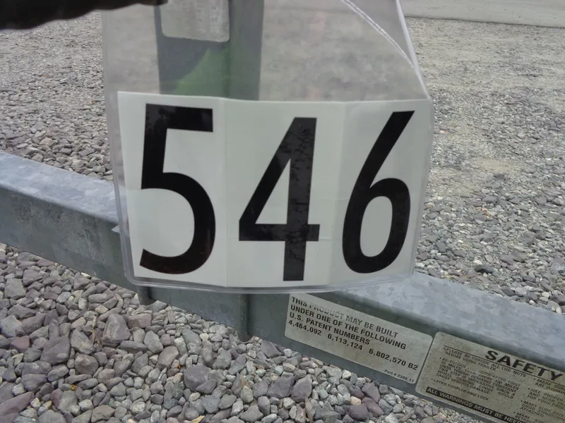 Slide: The Image of Number 546 on a metal beam, gravel ground in background. - 13