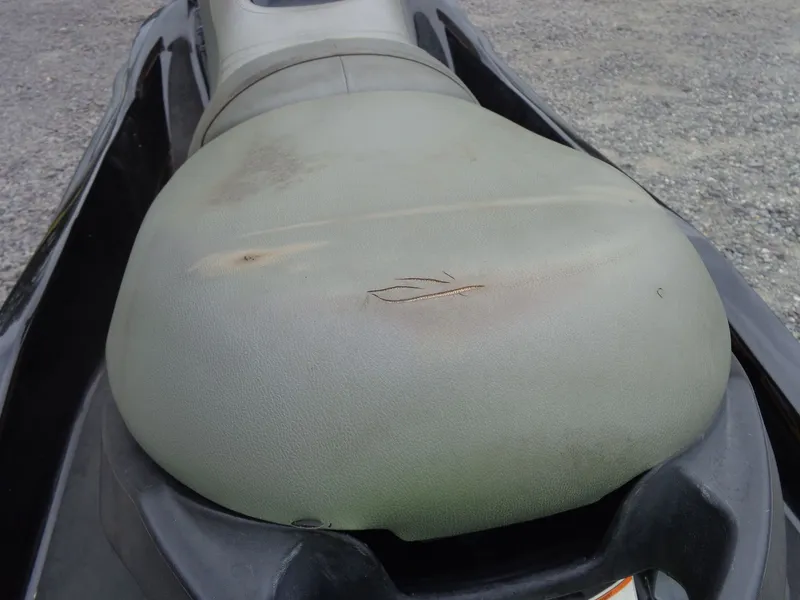 Slide: The Image of 2007 Sea-Doo RXT jet ski with worn seat on gravel surface. - 8