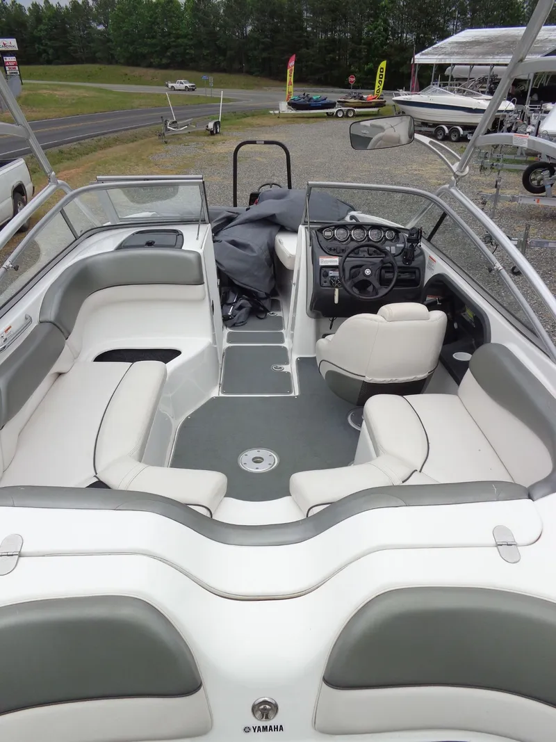 Slide: The Image of Interior of a 2008 Yamaha AR210 boat with gray and white seating. - 13