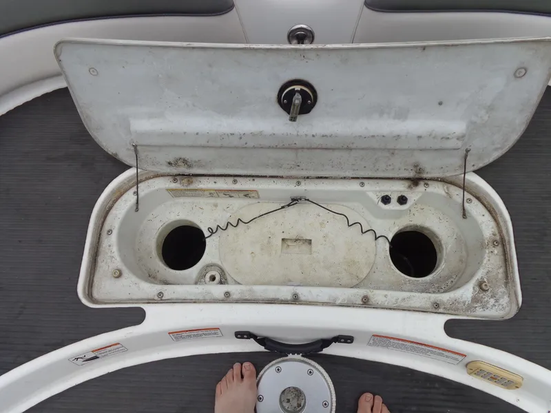 Slide: The Image of Open storage compartment lid on a 2008 Yamaha AR210 boat. - 26
