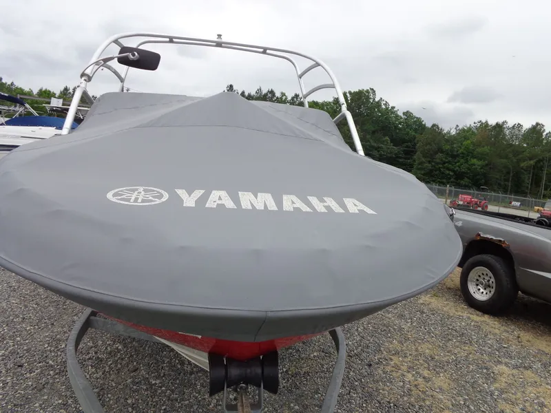 Slide: The Image of 2008 Yamaha AR210 boat with gray cover on gravel lot. - 3