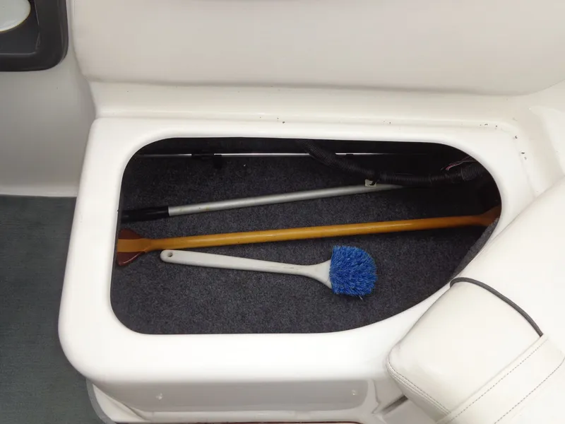 Slide: The Image of Storage compartment in 2008 Yamaha AR210 boat with cleaning tools. - 30