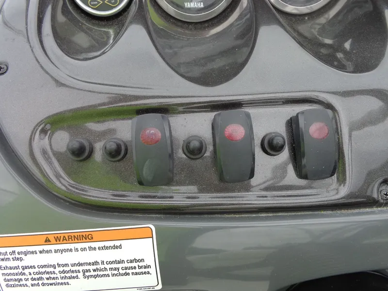 Slide: The Image of Control panel of a 2008 Yamaha AR210 boat with warning label. - 49