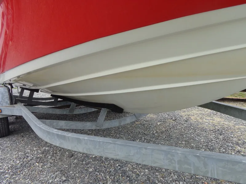Slide: The Image of Underside of a red 2008 Yamaha AR210 boat on trailer. - 9