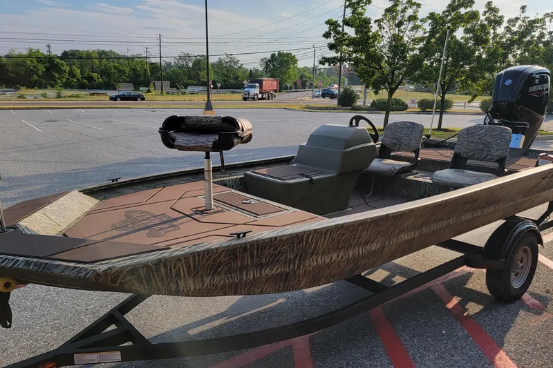 Slide: The Image of 2026 Tracker Grizzly 1754 SC boat in parking lot, featuring camouflage design and Mercury engine. - 3